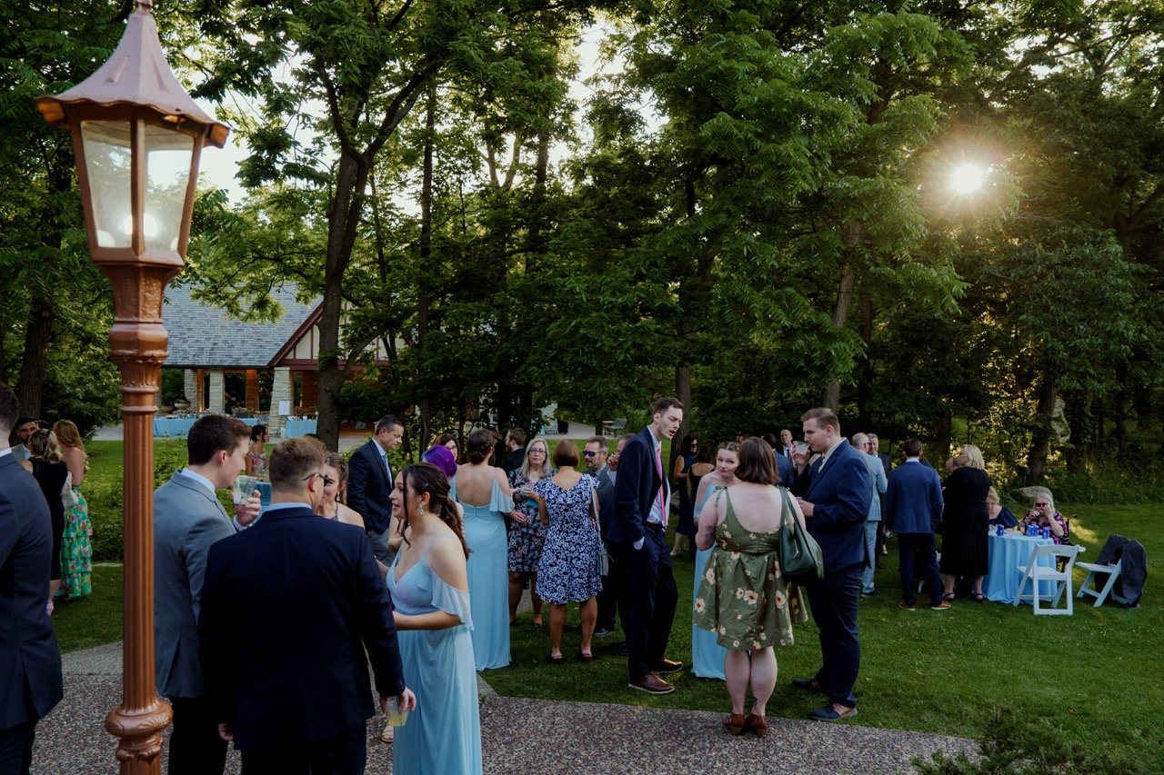 Cocktail hour wedding guests mingling outside Redfield Estate house