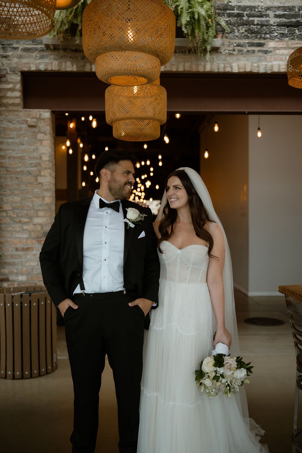 Bride and groom inside venue laughing with each other in Rockwell on the River