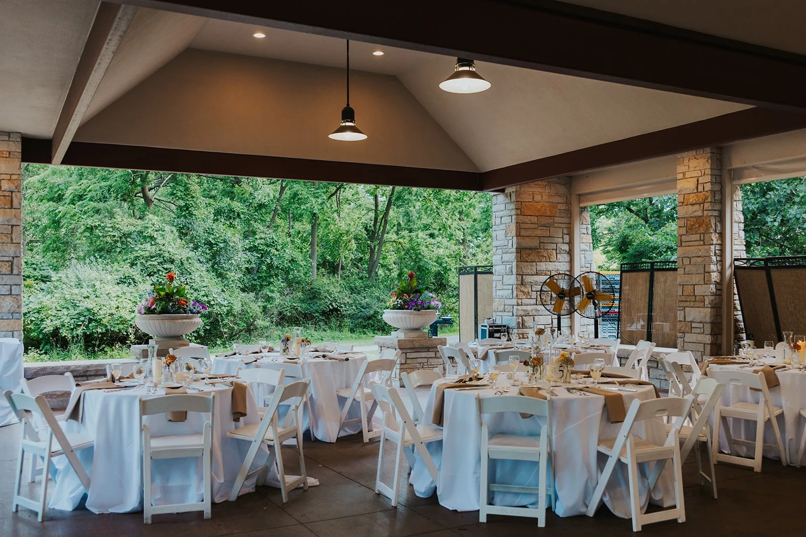 Wedding reception tablescapes with white linen and chairs and small decorations