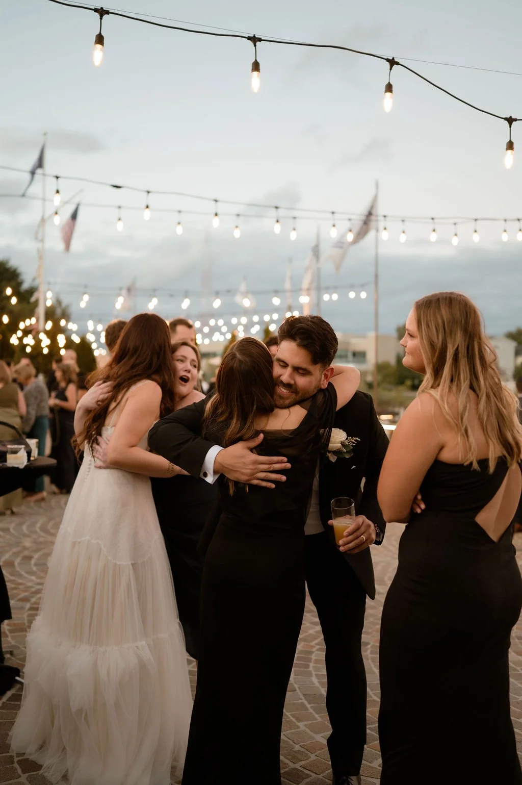bride and groom hugging guests at cocktail hour outdoors