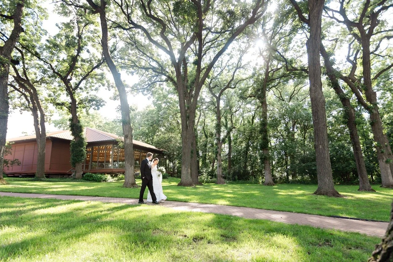 Couple walking outdoors near Grand Oaks Pavilion at Hyatt Lodge