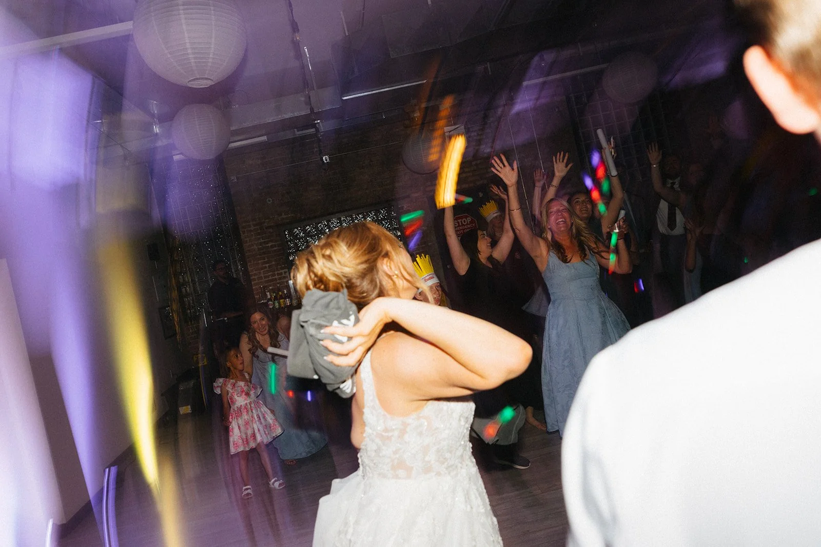 Bride throwing T-Shirt for t-shirt toss at wedding reception at Floating World Gallery in Chicago