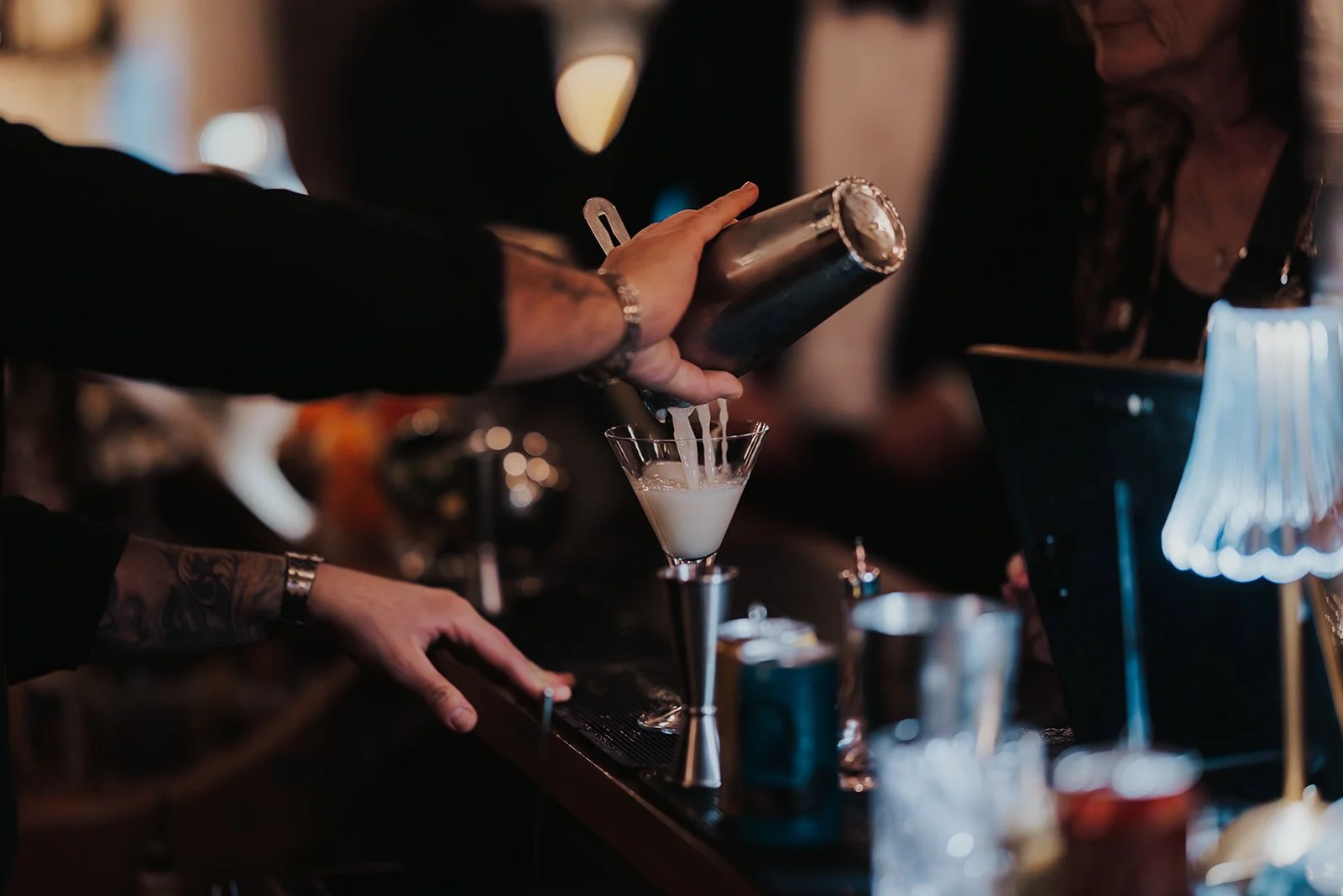 bartender pouring drink during cocktail hour