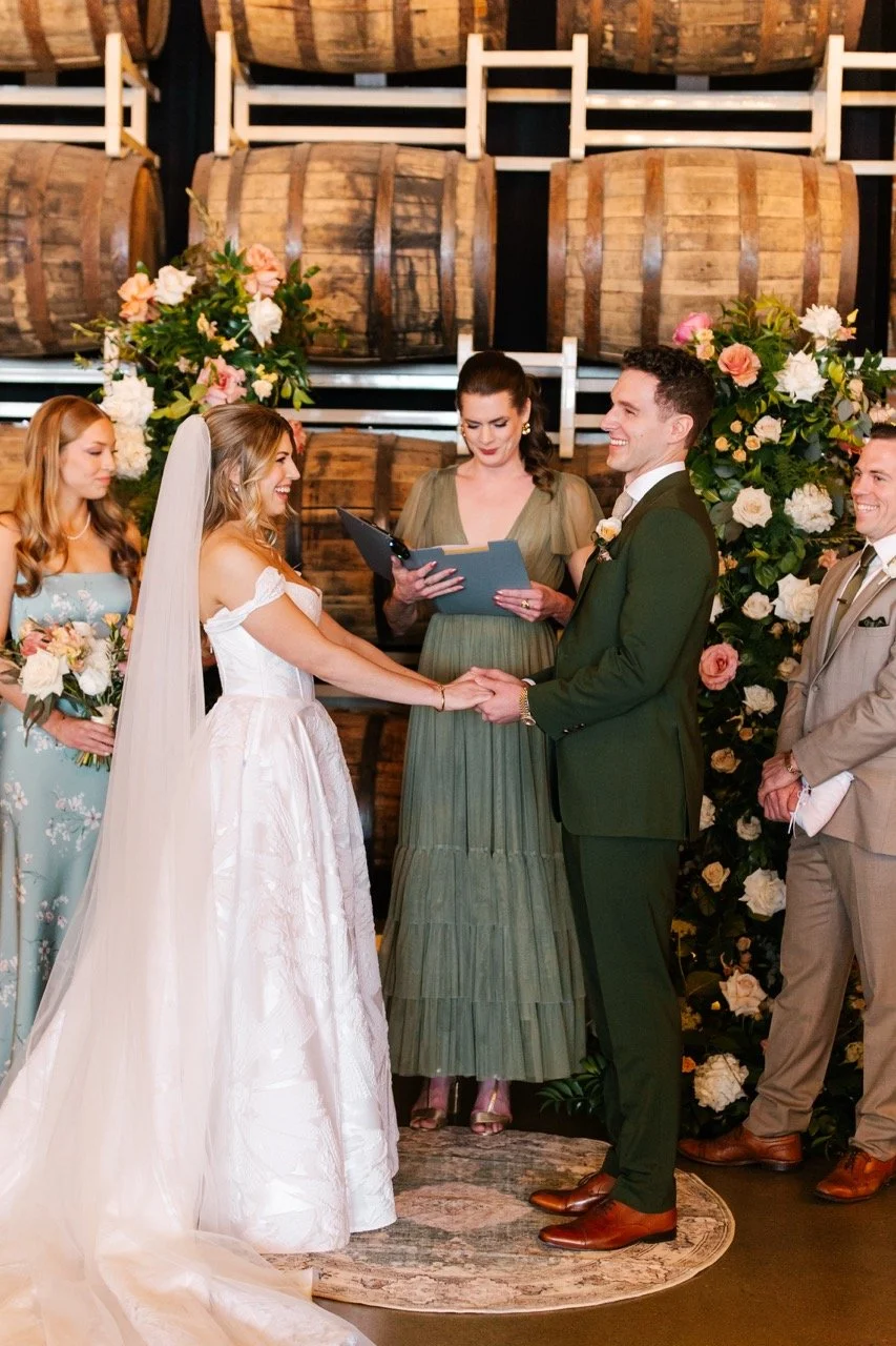 Couple holding hands laughing at wedding ceremony at Goose Island Barrel House