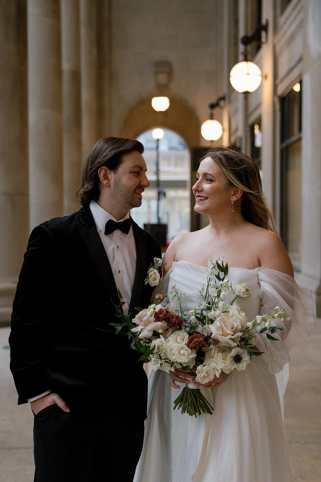 Bride and groom smiling at each other during photos at Union Station in Chicago