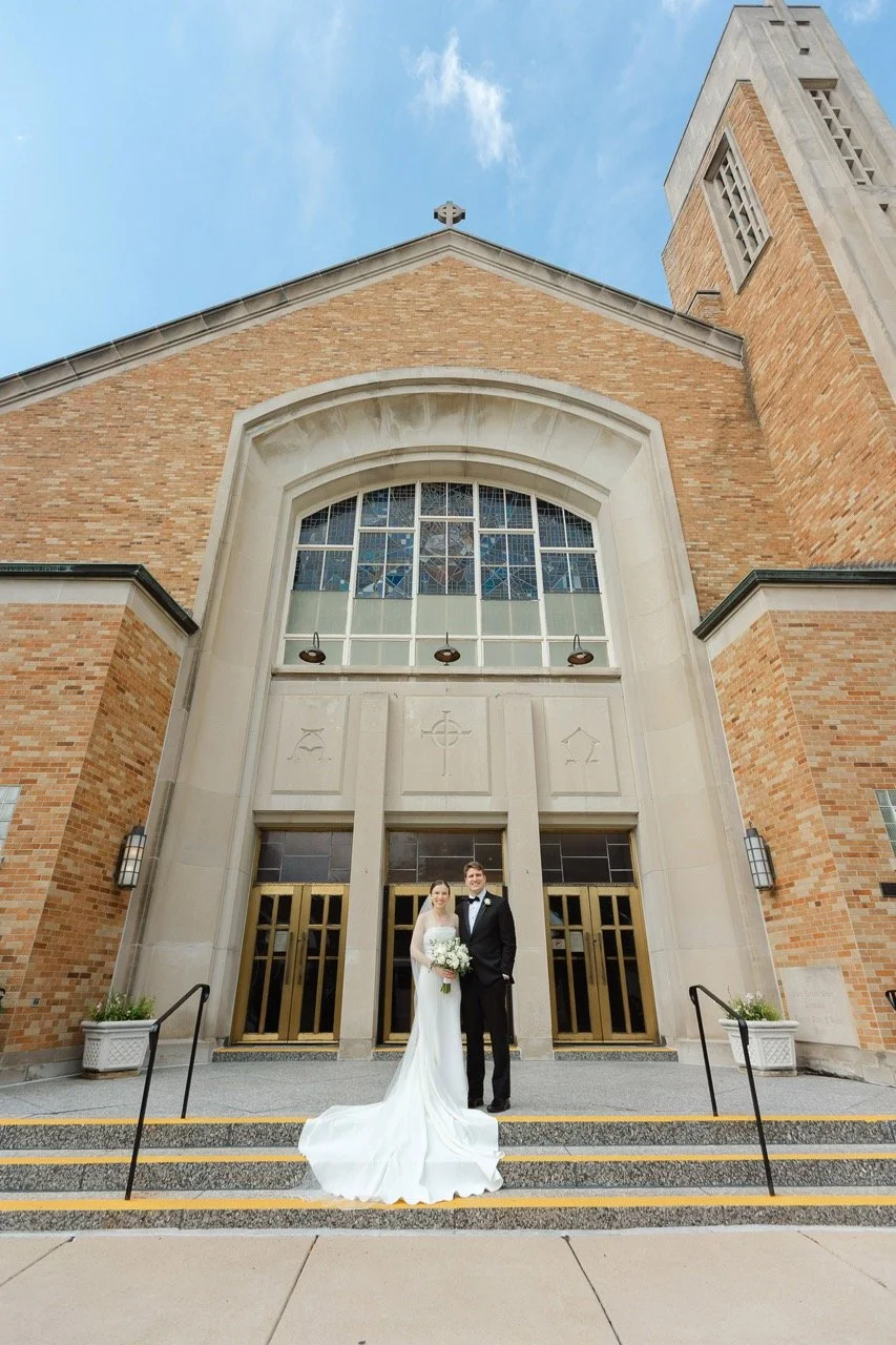 Bride and groom standing outside church after wedding ceremony far away so you can see the church building