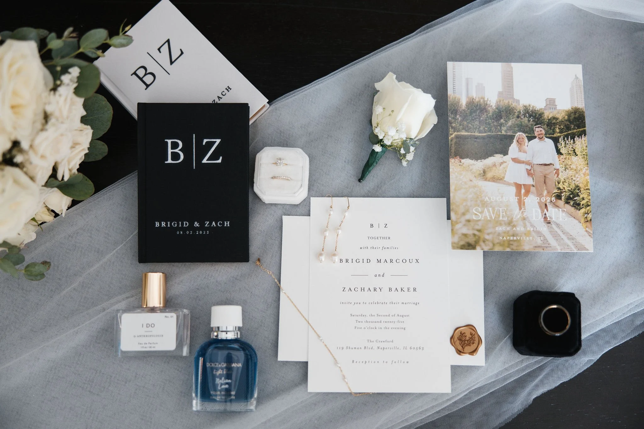 wedding invitation vows perfum rings and jewelry flatlay details shot on top of veil