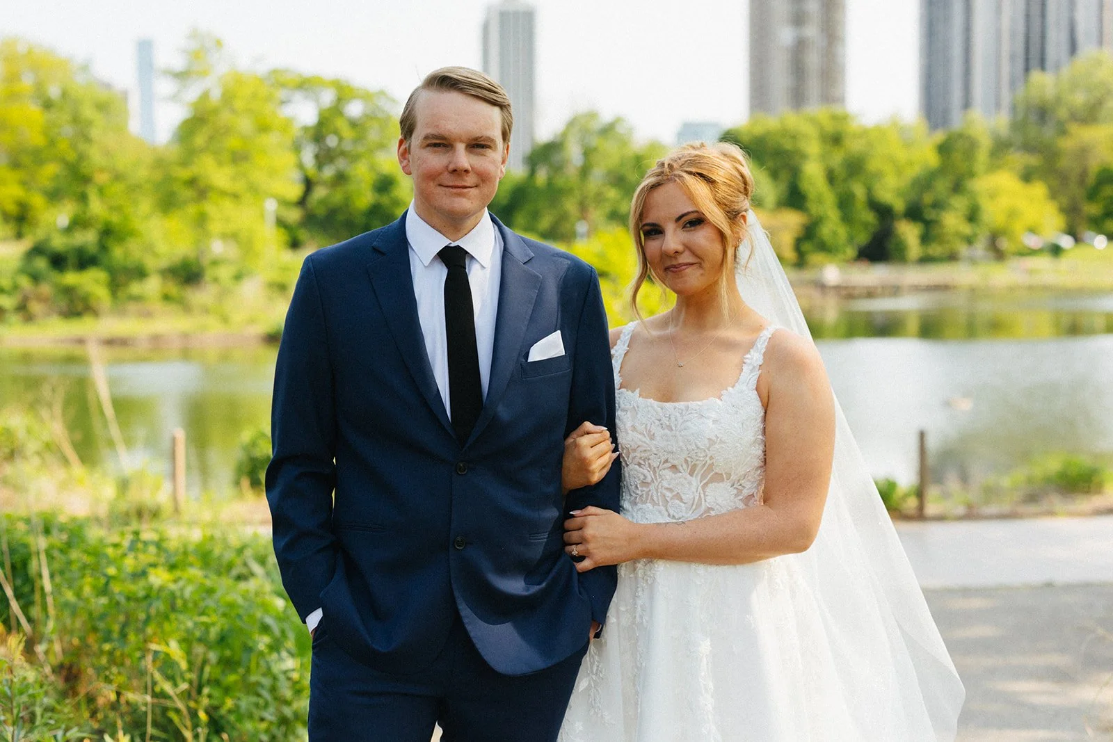 Couple grinning at camera with Lincoln Park Zoo outdoors as background