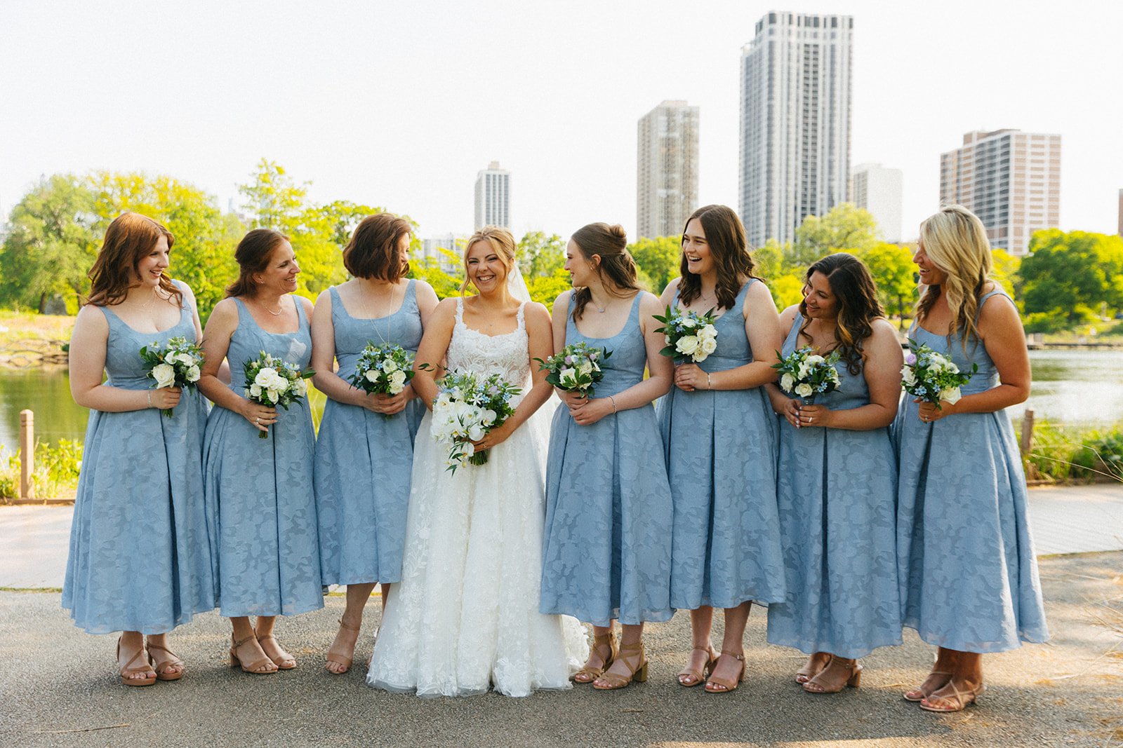 Bridesmaids looking at bride and laughing in Lincoln Park Zoo