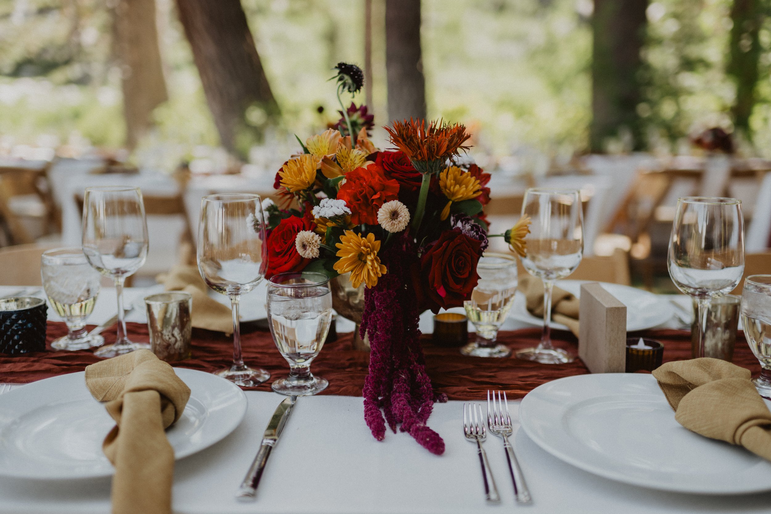 Floral arrangements for this summer wedding in the mountains included an ombre floral arbor (mandap / chuppah) and bright wedding bouquet.