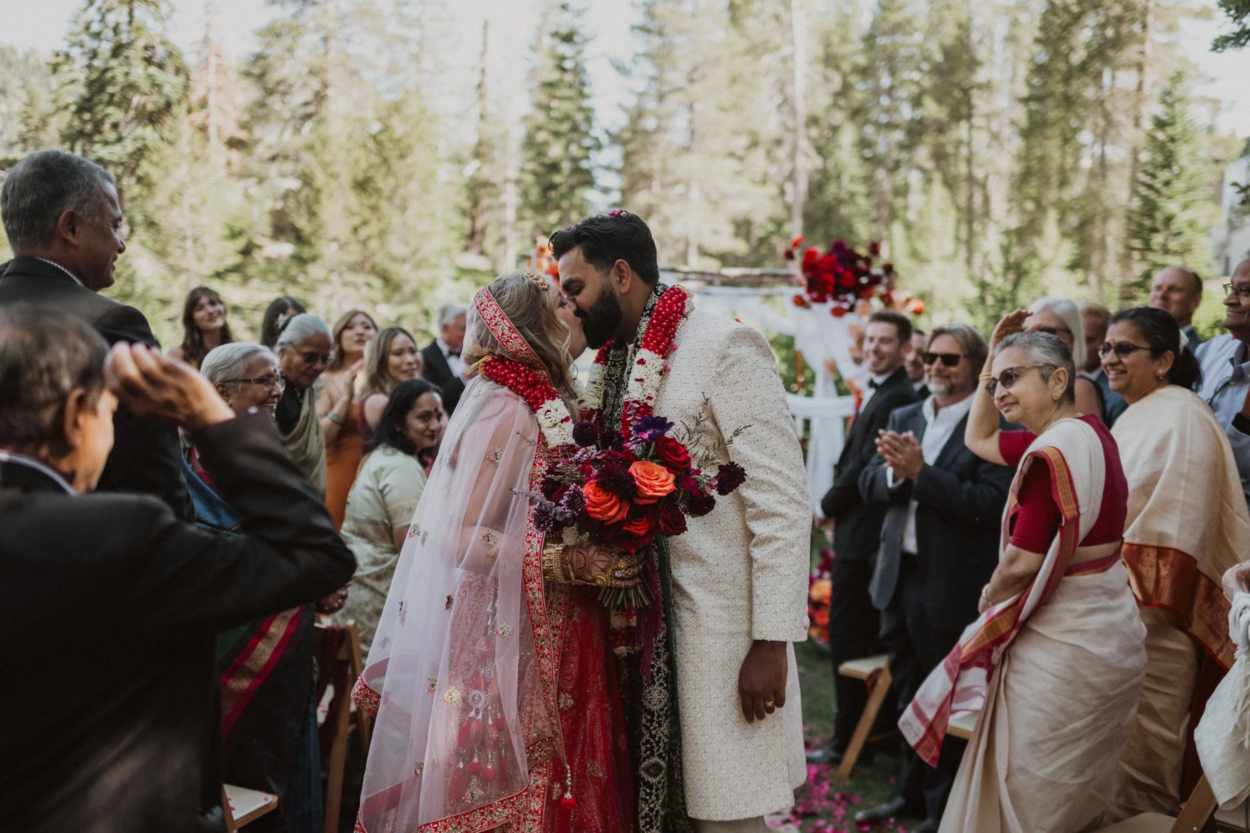 Floral arrangements for this summer wedding in the mountains included an ombre floral arbor (mandap / chuppah) and bright wedding bouquet.