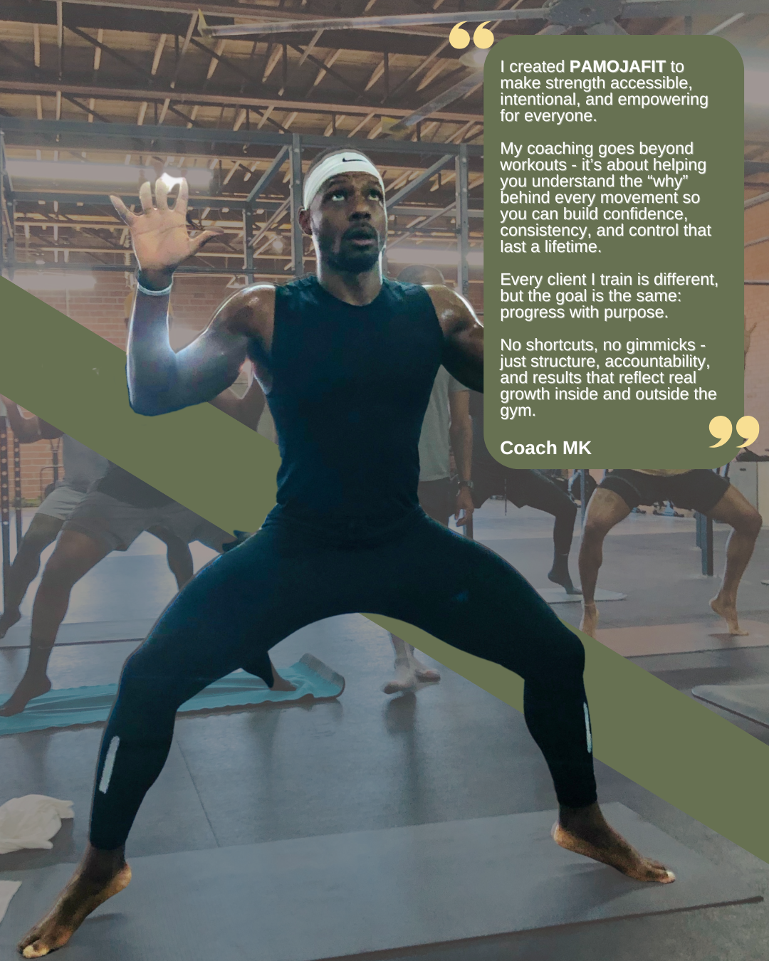 A man in a black tank top and black leggings, wearing a white headband, participating in a yoga or fitness class in a gym. Other people are visible in the background, also engaged in stretching or yoga poses.