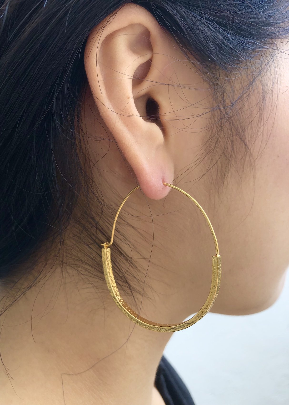 gold basket hoops on model lucy thompson.jpg
