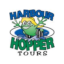 Logo of Harbour Hopper Tours featuring a cartoon frog wearing a yellow hat and splashing through water, with the words "Harbour Hopper Tours" in bold letters.
