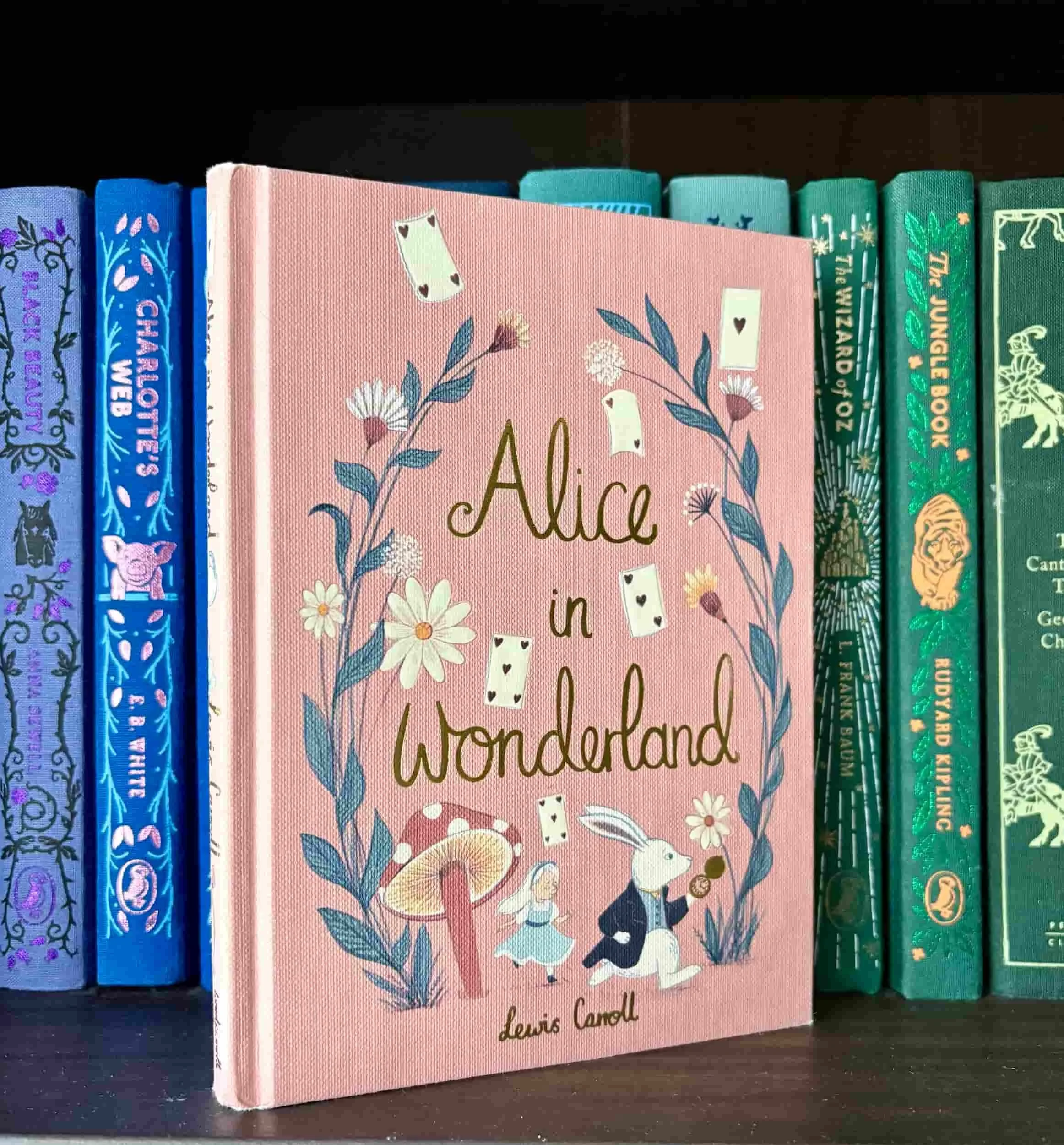 Personal copy of Alice's Adventures in Wonderland classic children's book opened on a table.