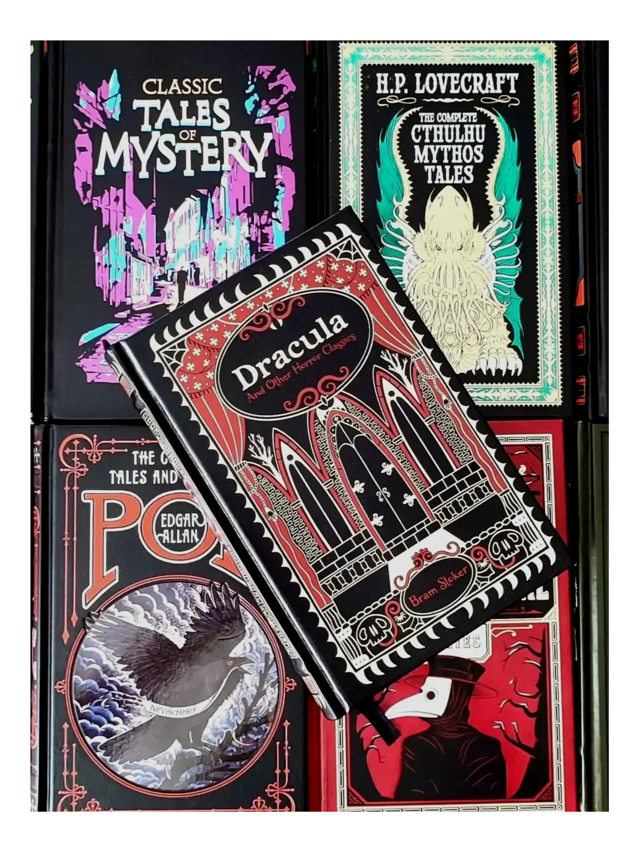 Dracula and Other Horror Classics by Bram Stoker laying onto of 4 other leatherbound horror books