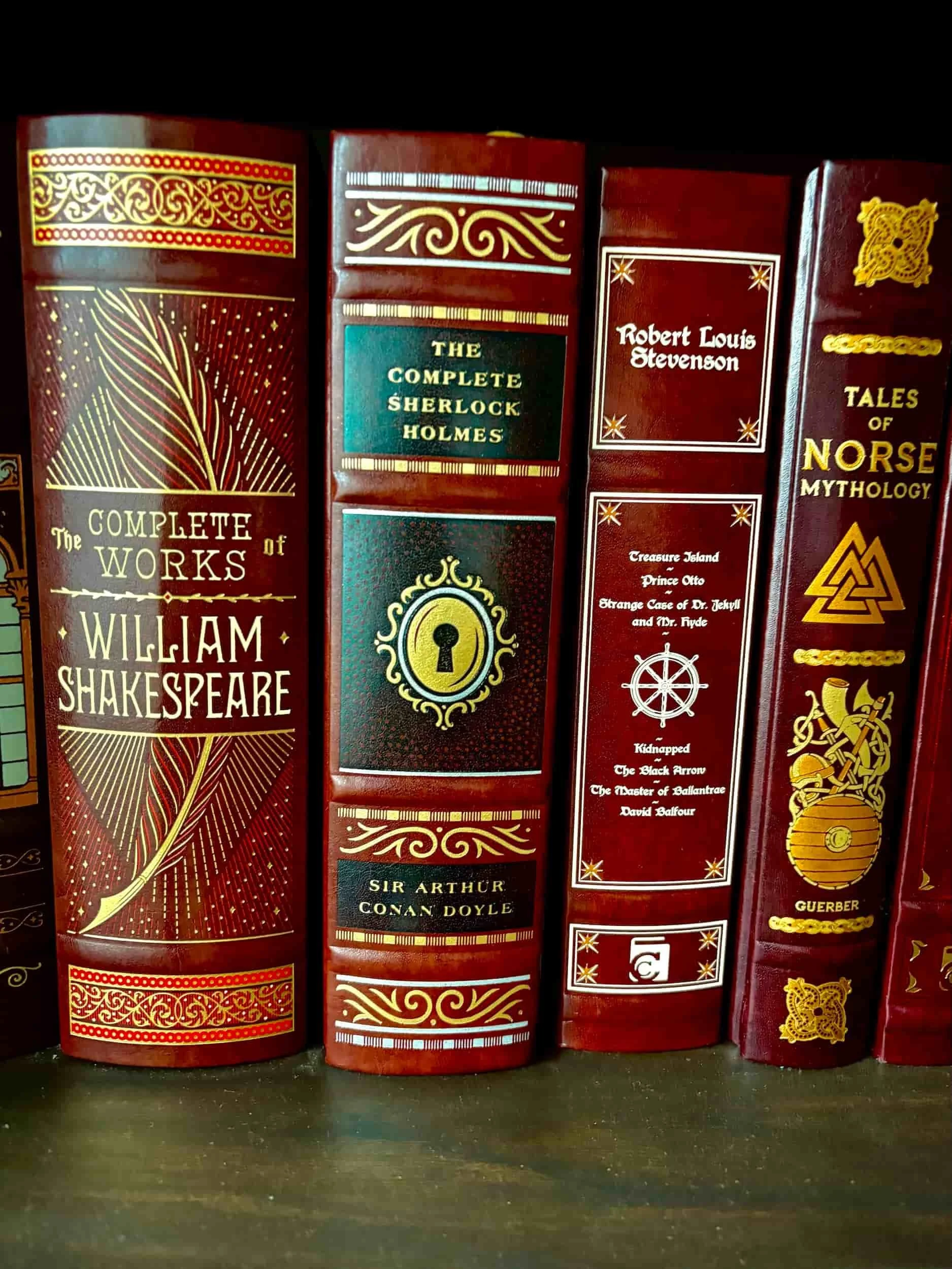 Detailed spine of the Barnes & Noble Sherlock Holmes leatherbound edition showing intricate gold keyhole stamping.
