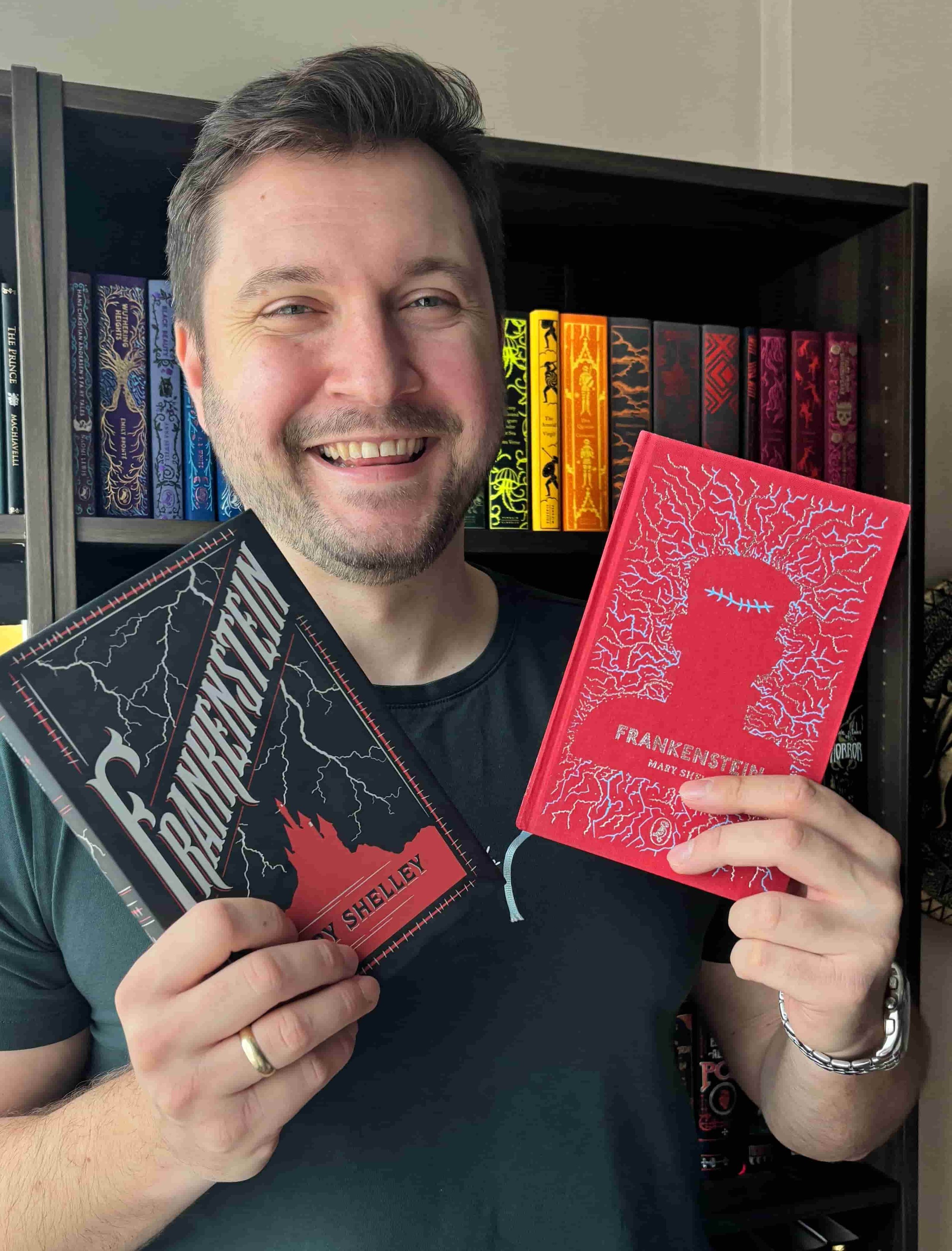Alex Nikolov of His and Hers Book Club holding 2 copies of Frankenstein for8 Best Horror Authors & Their Must-Read Books (2026)
