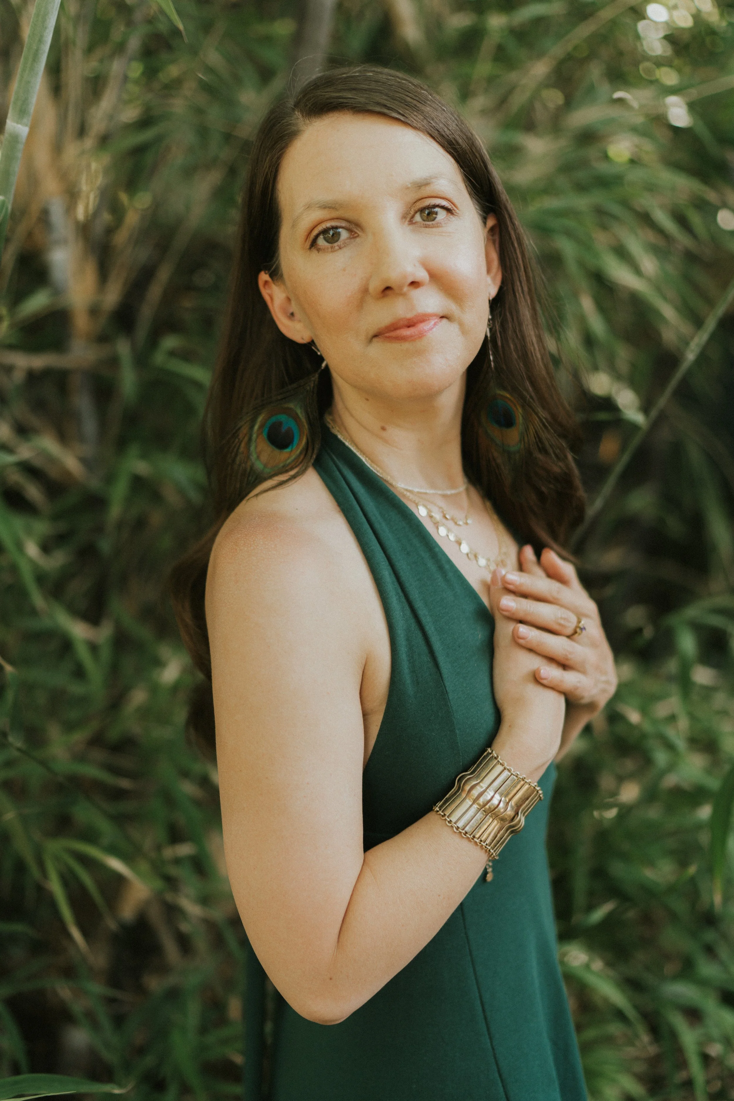 Close-up of a woman’s hand on her chest, showing somatic embodiment and self-compassion.