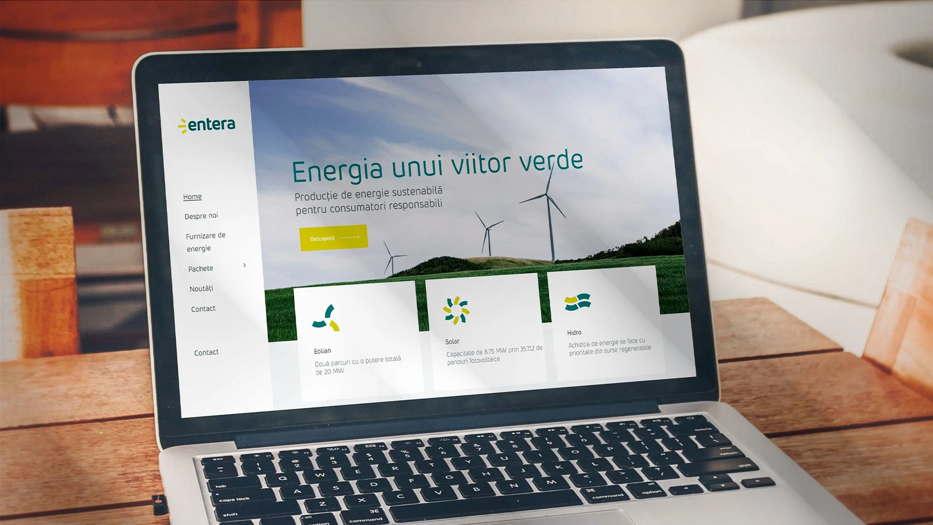 Entera renewable energy website displayed on a laptop, featuring branded digital content and wind energy imagery.