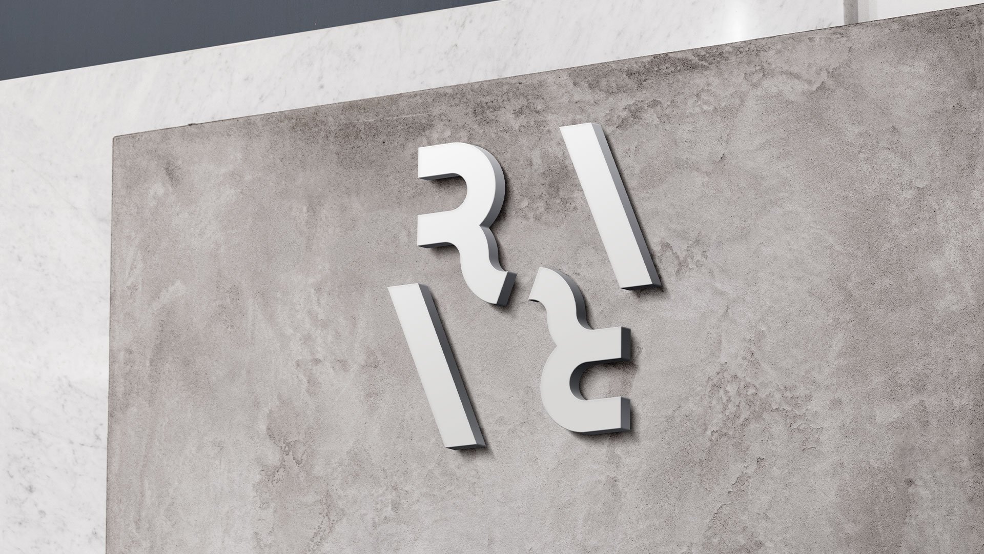 Rara Group geometric logo mounted on a textured concrete wall.
