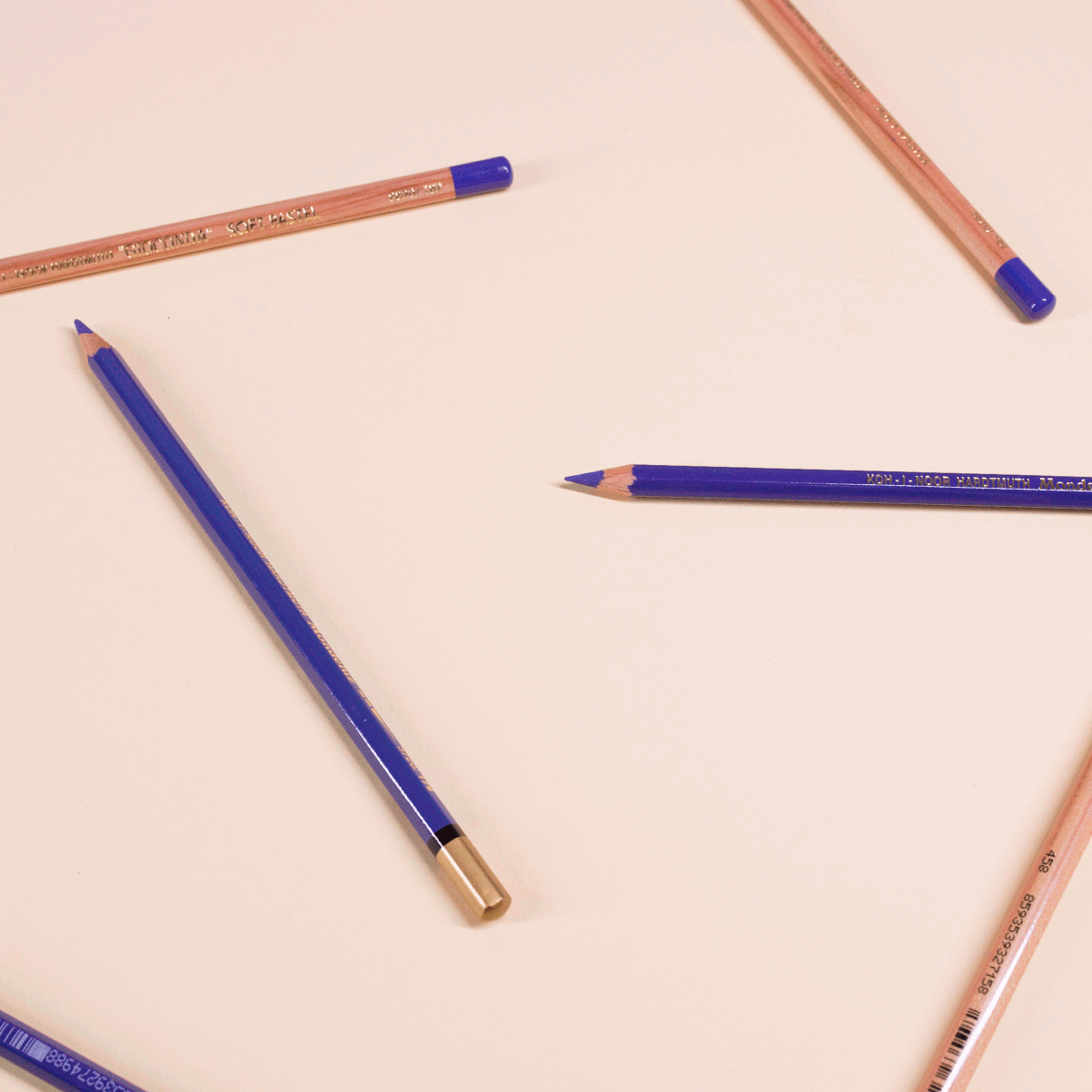 Animated purple pencils moving around a plum on a peach background.