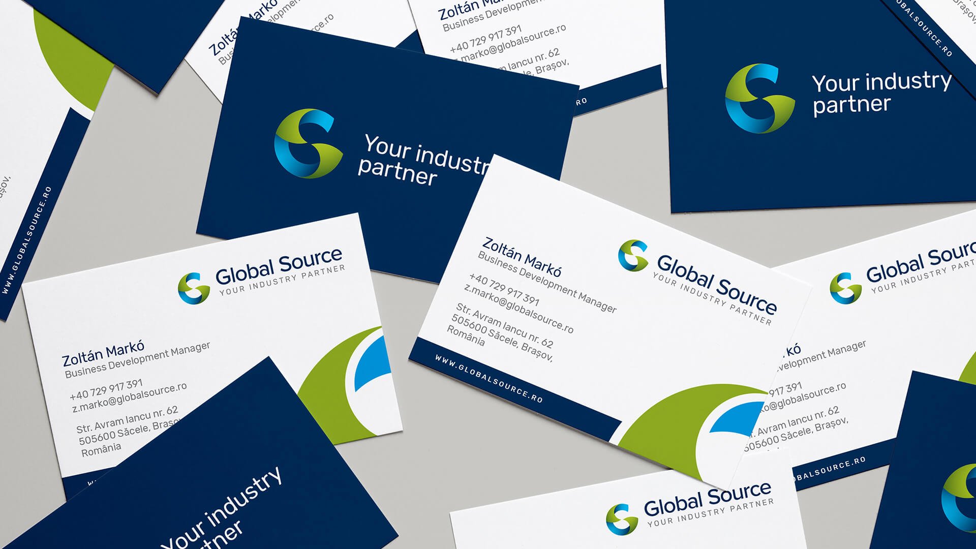 Global Source industrial brand identity showcased across business cards and stationery, featuring a geometric symbol and a navy blue, green and cyan colour palette.