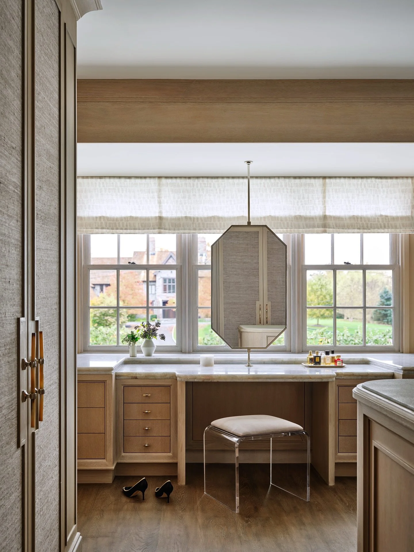 Her custom vanity was designed for moments of pause and ritual. Sunlight streams through a wall of windows, softened by Roman shades, and plays across the marble countertop and bespoke millwork.

Swipe for the before! 

Interior Design: @ebolognino
A