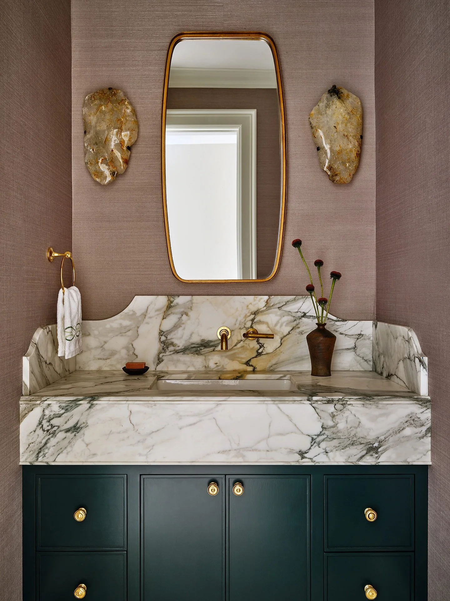 A jewel box of stunning materials. ✨ Calacatta Paonazza marble, grasscloth, and crystal shape the pantry powder room at our Greenwich, CT project with warmth and sophistication. 

Interior Design:&nbsp;@ebolognino
Architecture:&nbsp;@brooksandfalotic