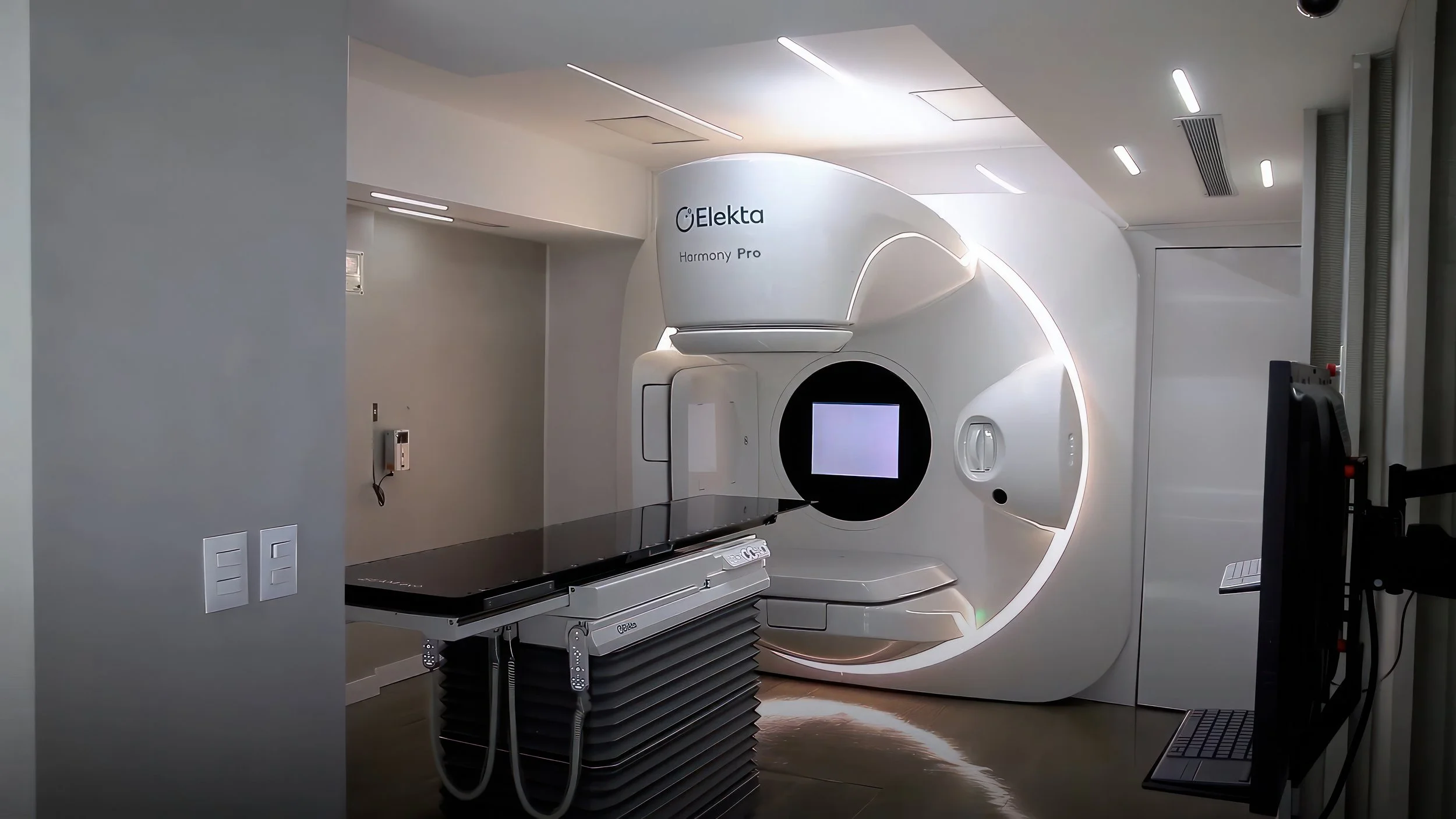 Escáner de resonancia magnética en una sala de hospital moderna y limpia, con luces LED y equipo médico blanco.