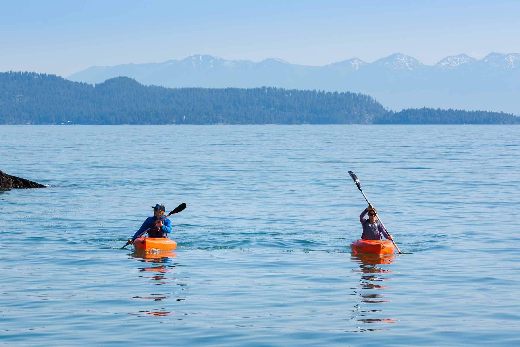 A couple kayaking on Flathead Lake in Lakeside, Montana with Wild Horse Island in the background