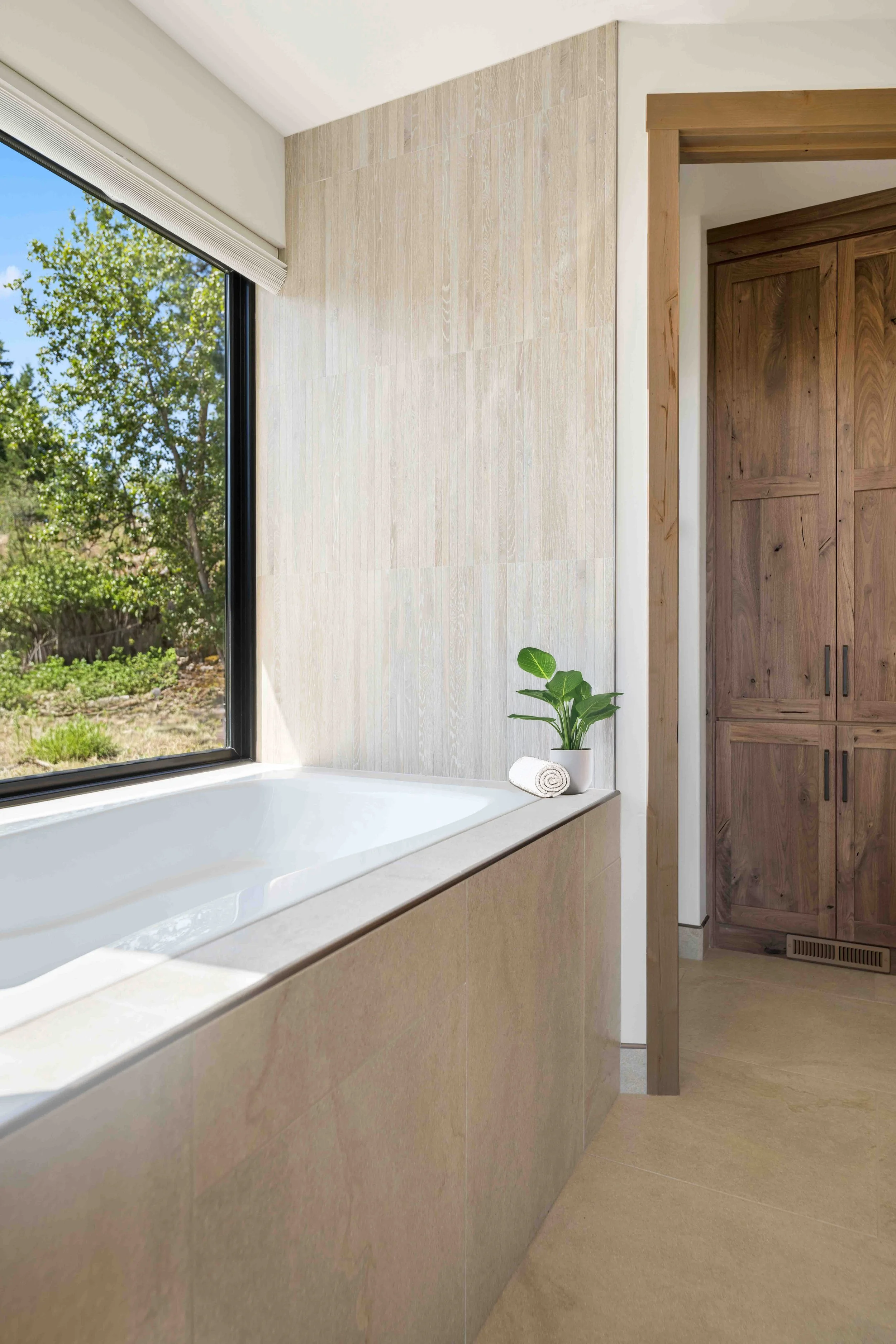 This primary bathroom boasts hickory cabinets, huge shower and an infinity tub.