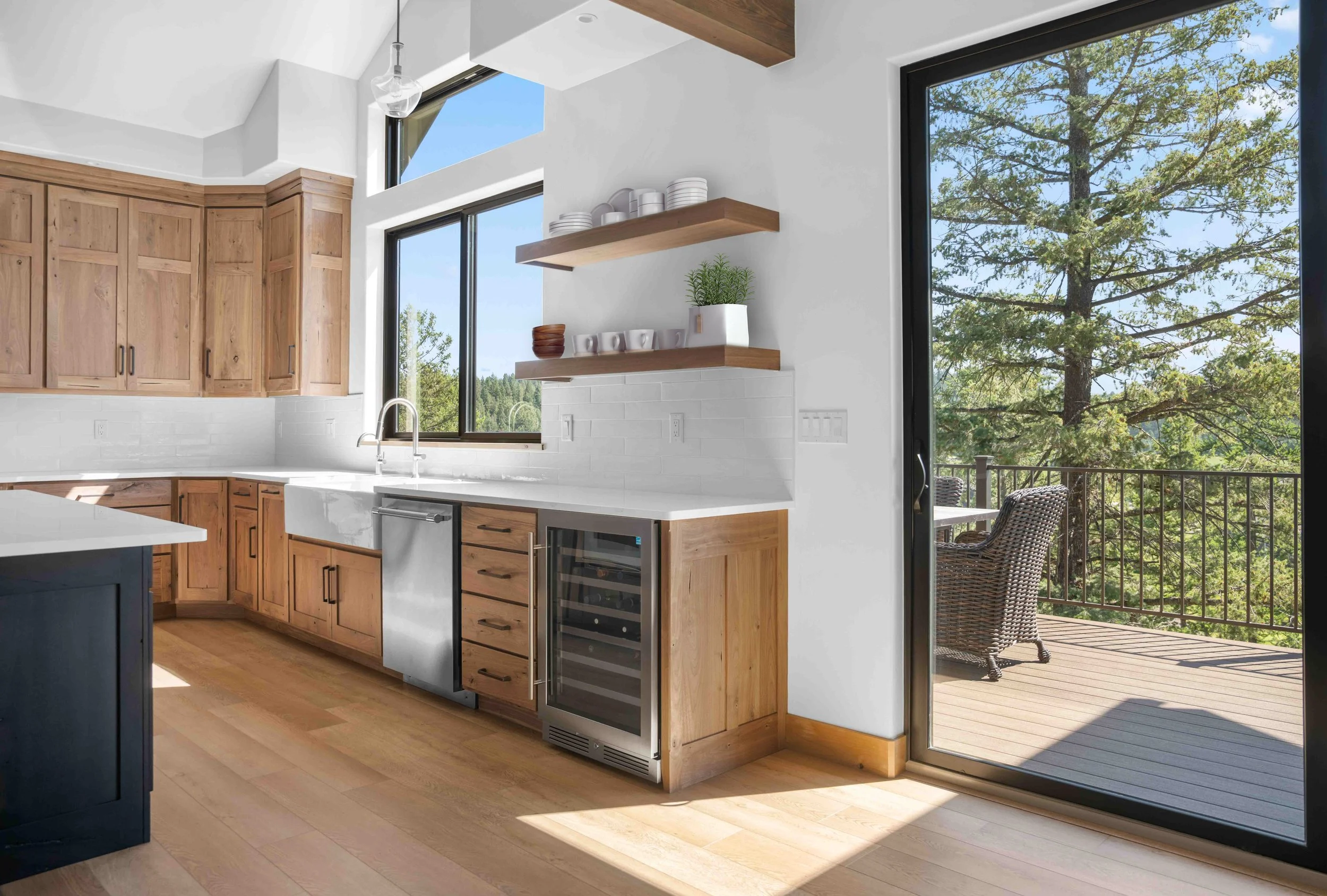 Modern hickory cabinets and weathered wood island adorn a rustic transitional kitchen in Bigfork, Montana.