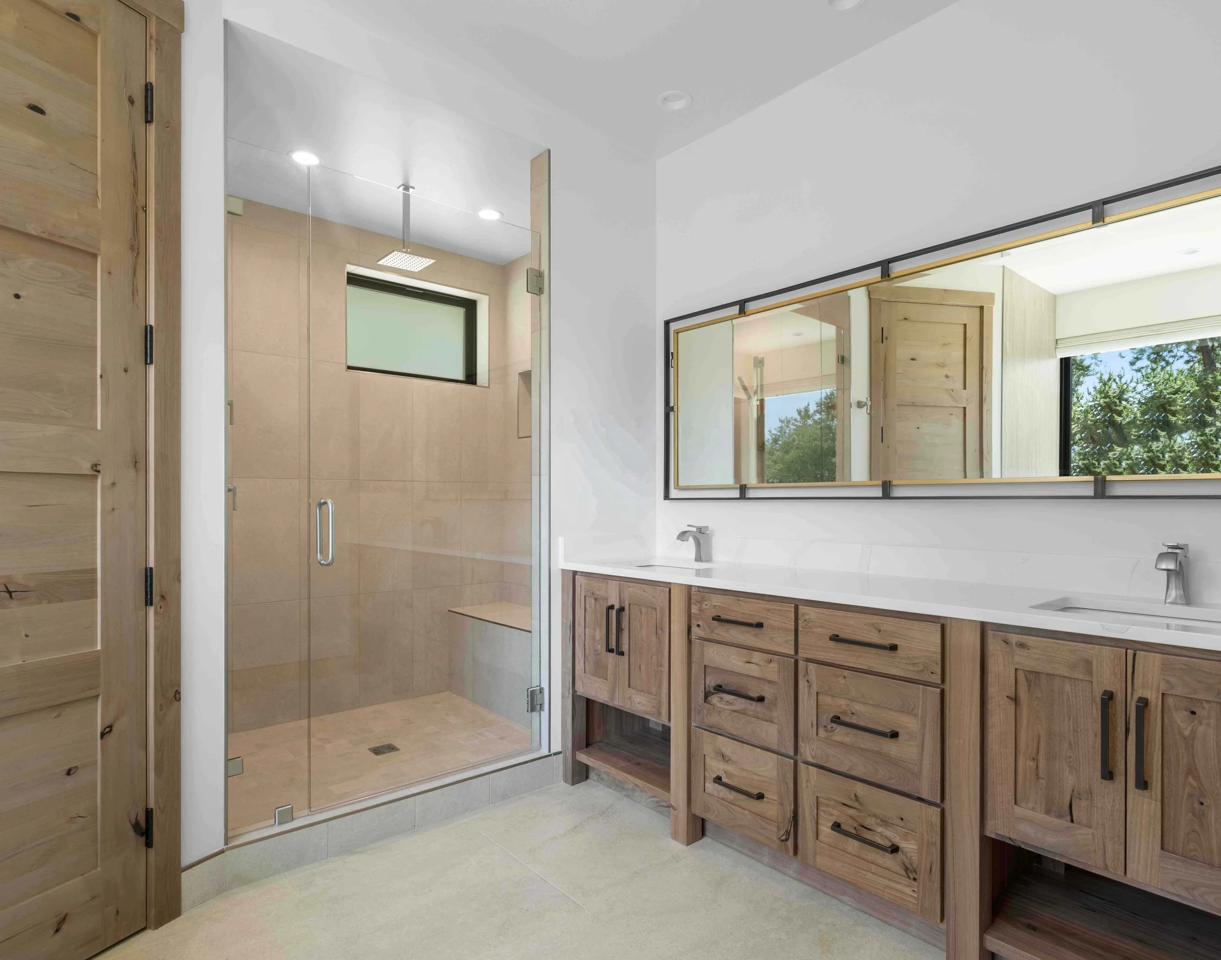 This primary bathroom boasts hickory cabinets, huge shower and an infinity tub.