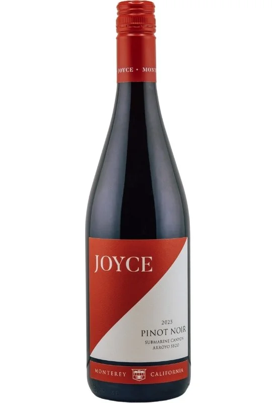A wine bottle with a diagonal design, featuring the name 'Joyce' at the top, and a crest logo with 'Pinot Noir' and location names 'Submarine Canyon' and 'Arroyo Seco' at the bottom.