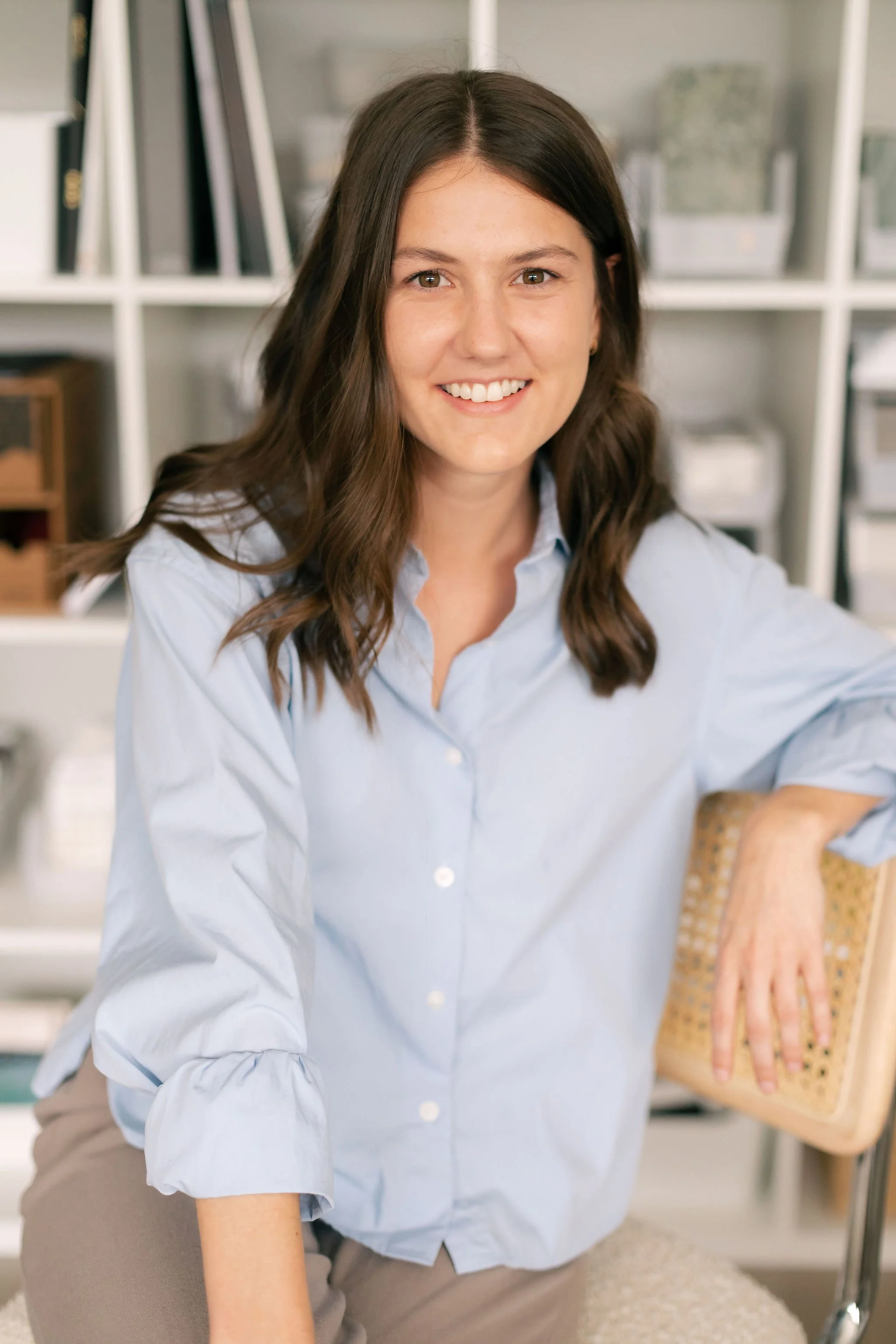 Mary Grace Smith, Studio Coordinator at Paige Studio, seated in the Dallas interior design studio.