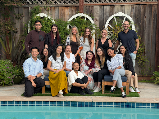 Group of people sitting by a pool