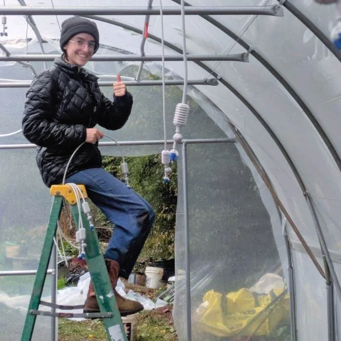 Trefoil Gardens intern Nelly Koz works inside a greenhouse in Woodstock, GA, learning drip irrigation and sustainable farming techniques that led to her acceptance into a Germany research internship.