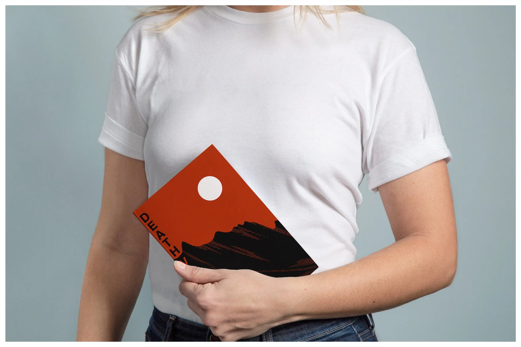 A book mockup using a design showcasing the location of Death Valley with a minimalism approach. Poster design by Carmelo Rossette.