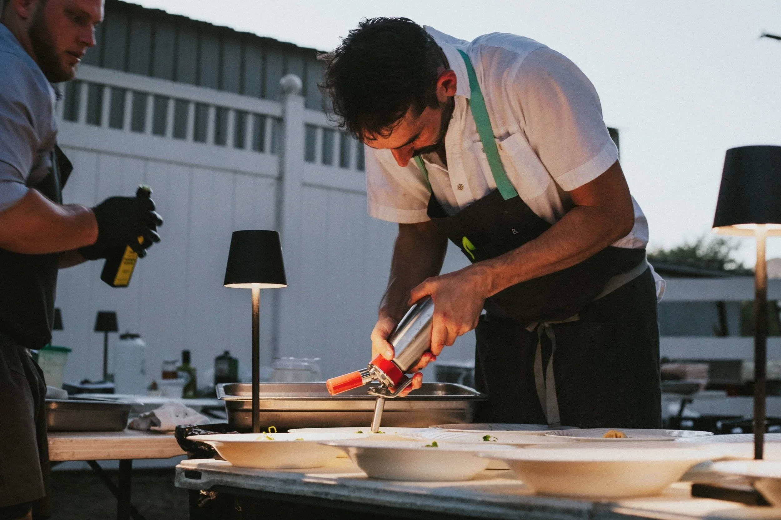 Chef Matt photographed preparing food at event held at Stones Throw Ranch
