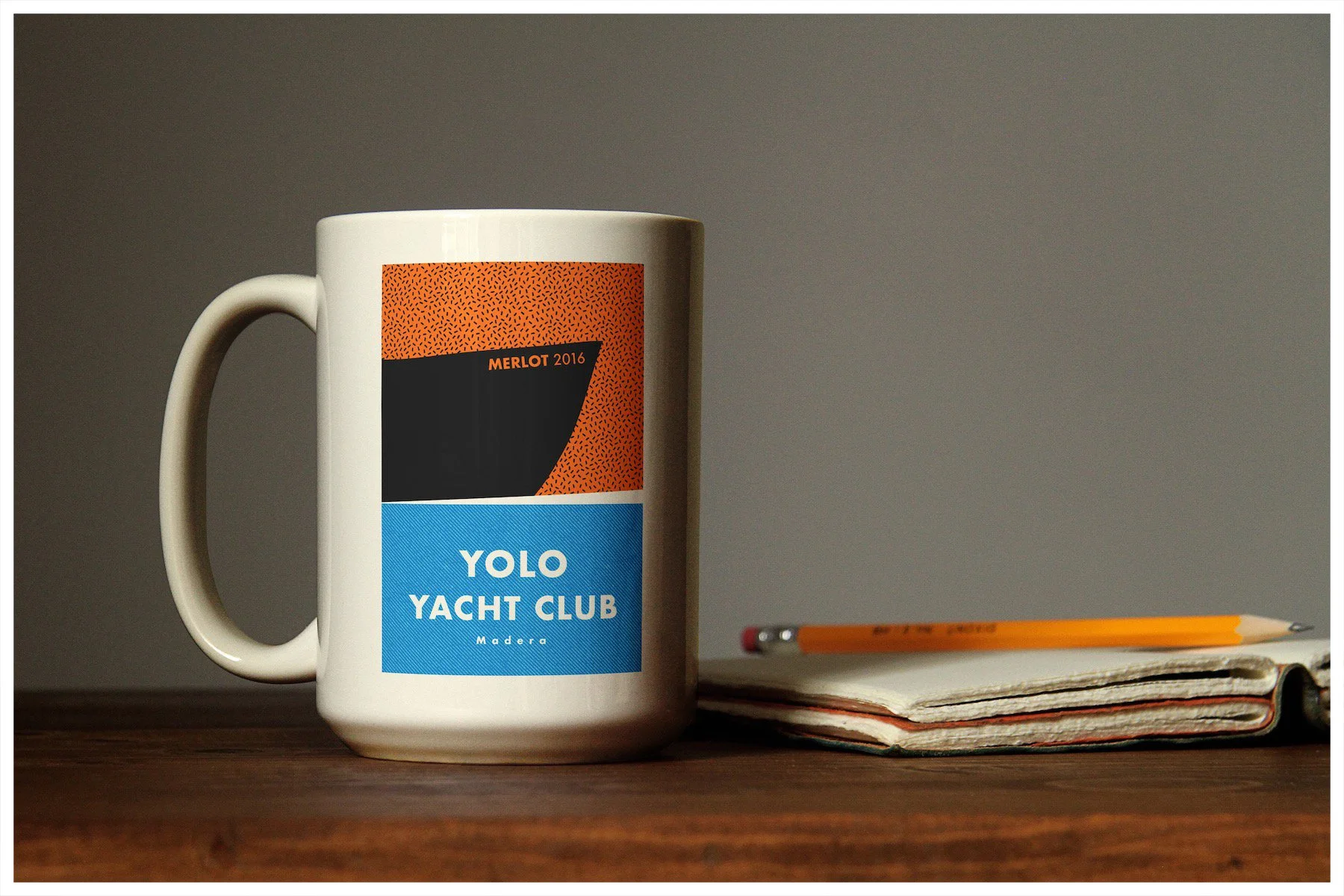 A coffee mug mockup using a design showcasing the fictitious company Yolo Yacht Club Wines with a minimalism approach. Poster design by Carmelo Rossette.