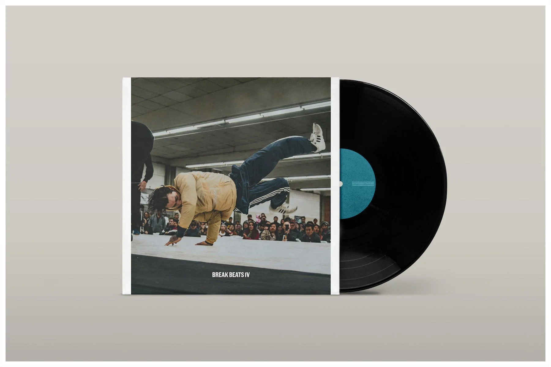 A vinyl record mockup of a Break Dancer competing in front of a packed crowd at at the Fresno Fairgrounds for The Next Level 2018 Breakin' Jam in Fresno, Ca. Photograph by Carmelo Rossette.