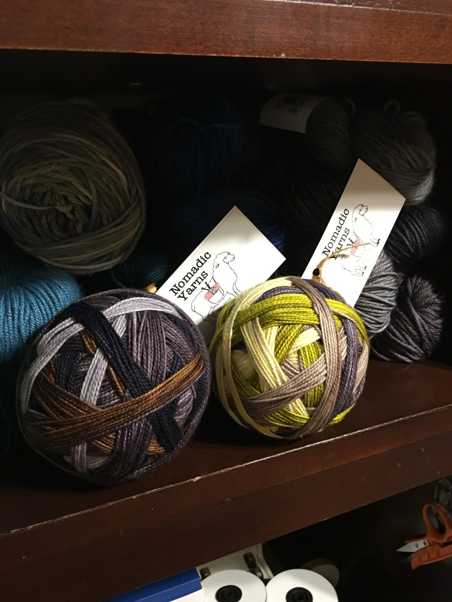 Shelf candy at its finest. 🧶✨
Self-striping sock yarn just begs to jump on the needles, doesn&rsquo;t it? If you grabbed one of these Nomadic Yarns balls right now, would you cast on socks, a cowl, or something totally different? Tell me below!
#Nom