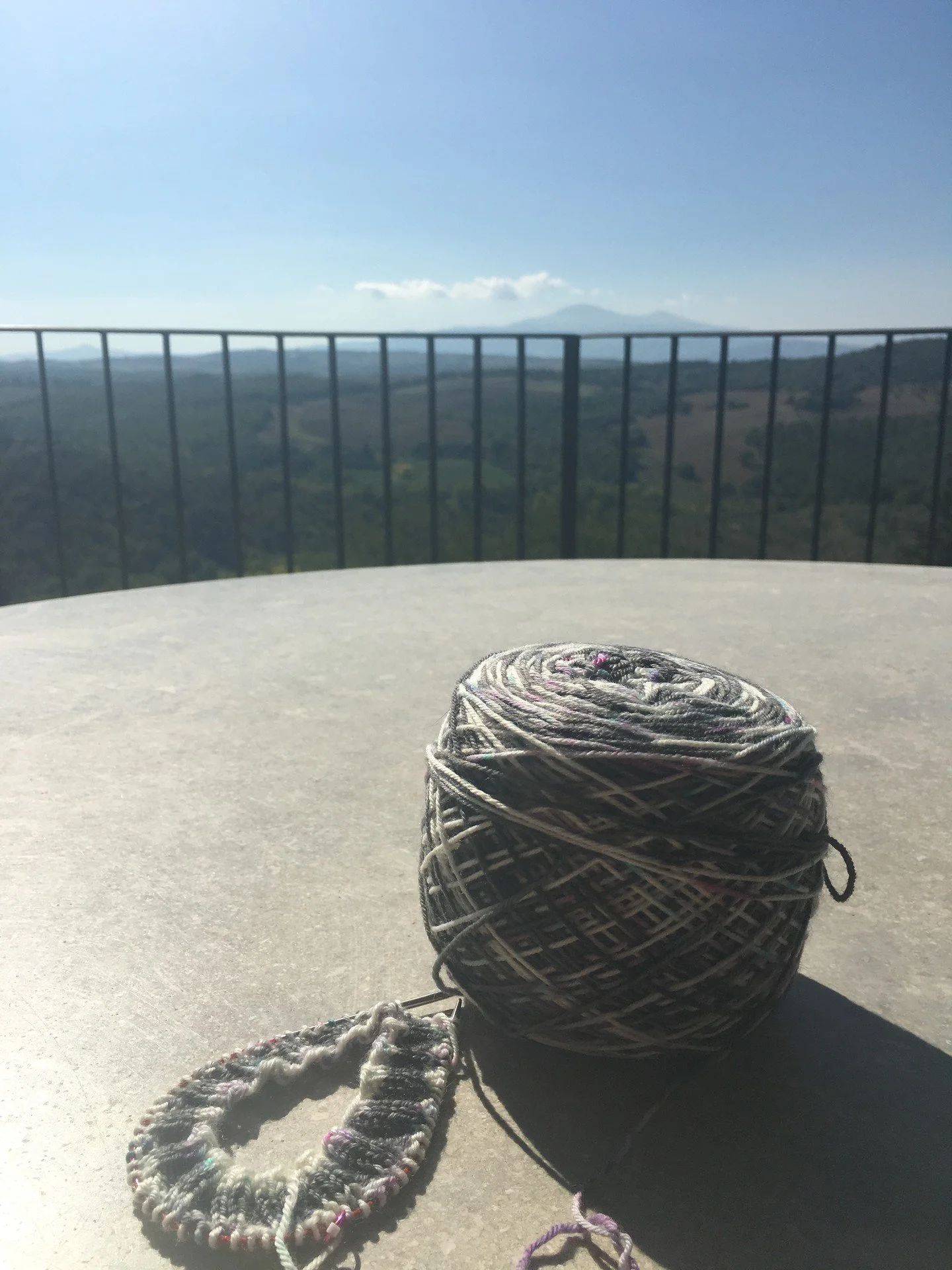 I once knit a pair of socks while sitting at small tables with a vista of the Tuscan landscape in Tuscany on a knitting retreat. Socks are always my go to on trips. Don't forget to take small easy to travel projects with you so you too can stop and e