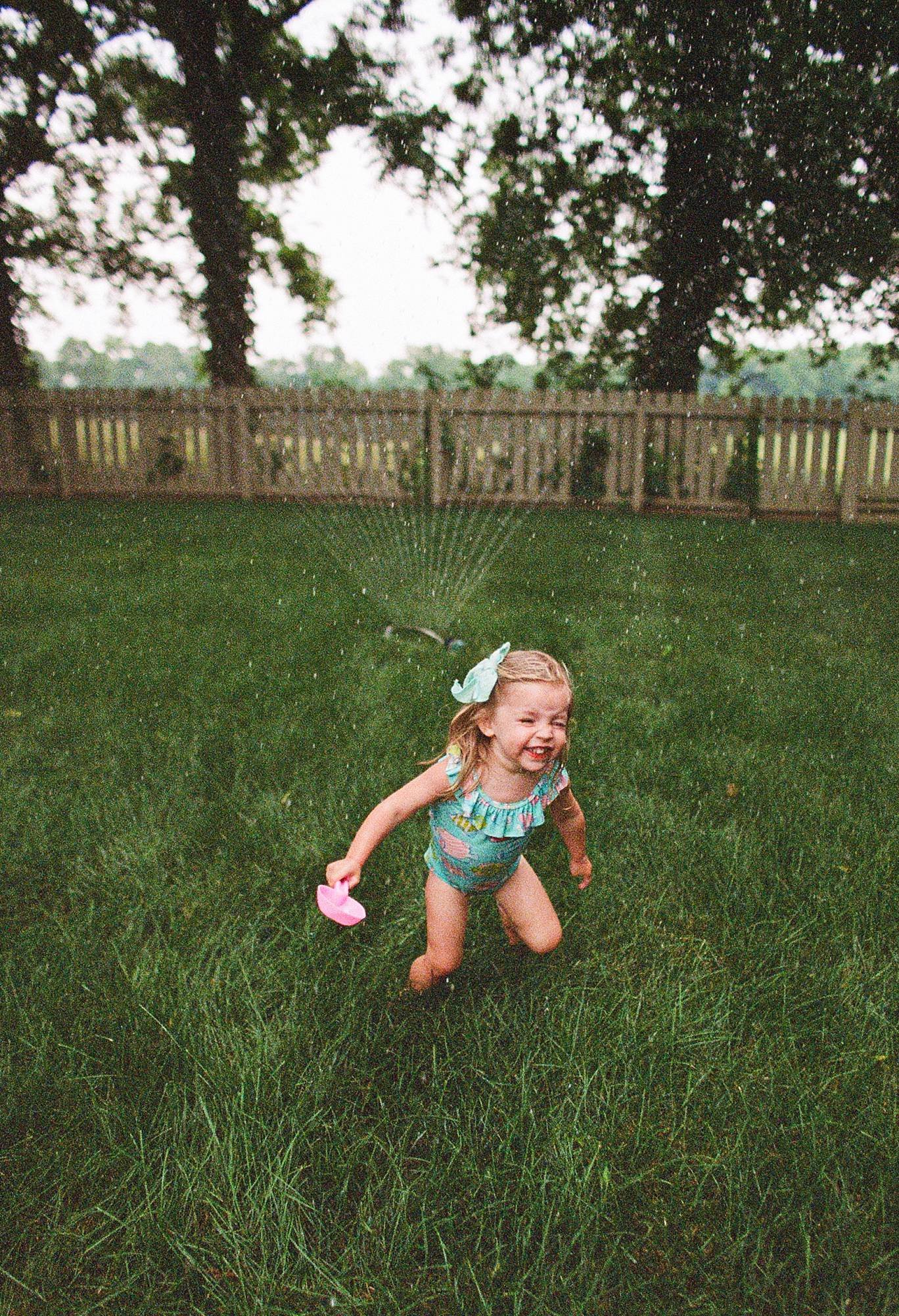 family photographer, family photography, summer photography, sprinkler in yard photo, film photography nashville, family film photographer, family film photographer nashville, film photographer tennessee, at home family photo session, lifestyle famil