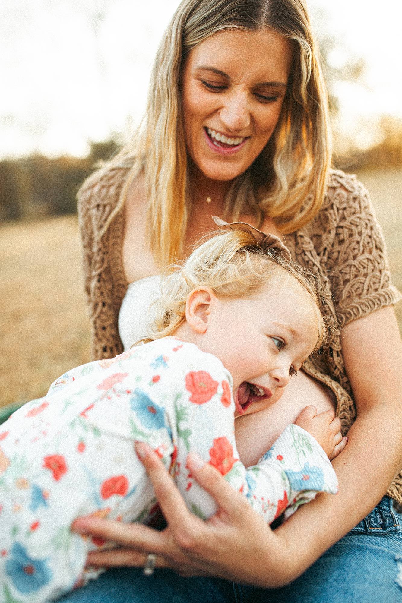 sister hugging baby sister maternity session