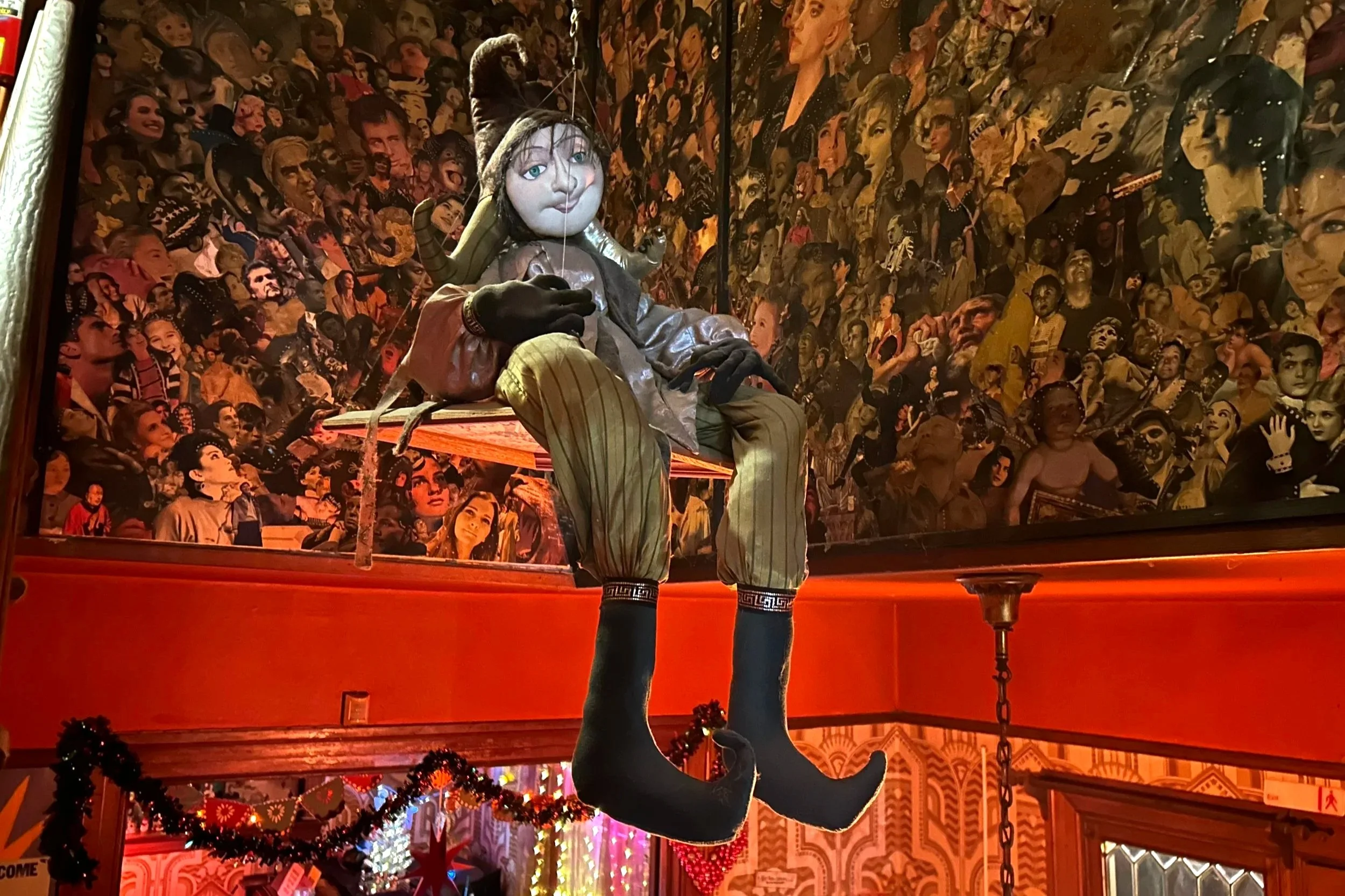 Unsettling doll on swing hangs from ceiling of coffee shop