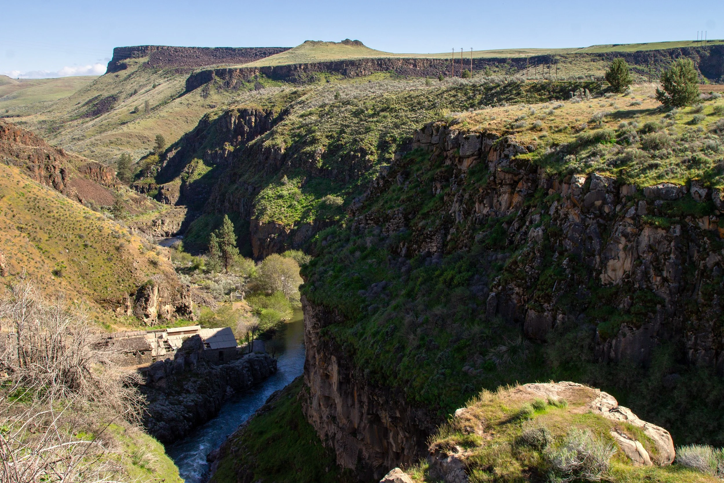 Old building at base of dramatic canyon