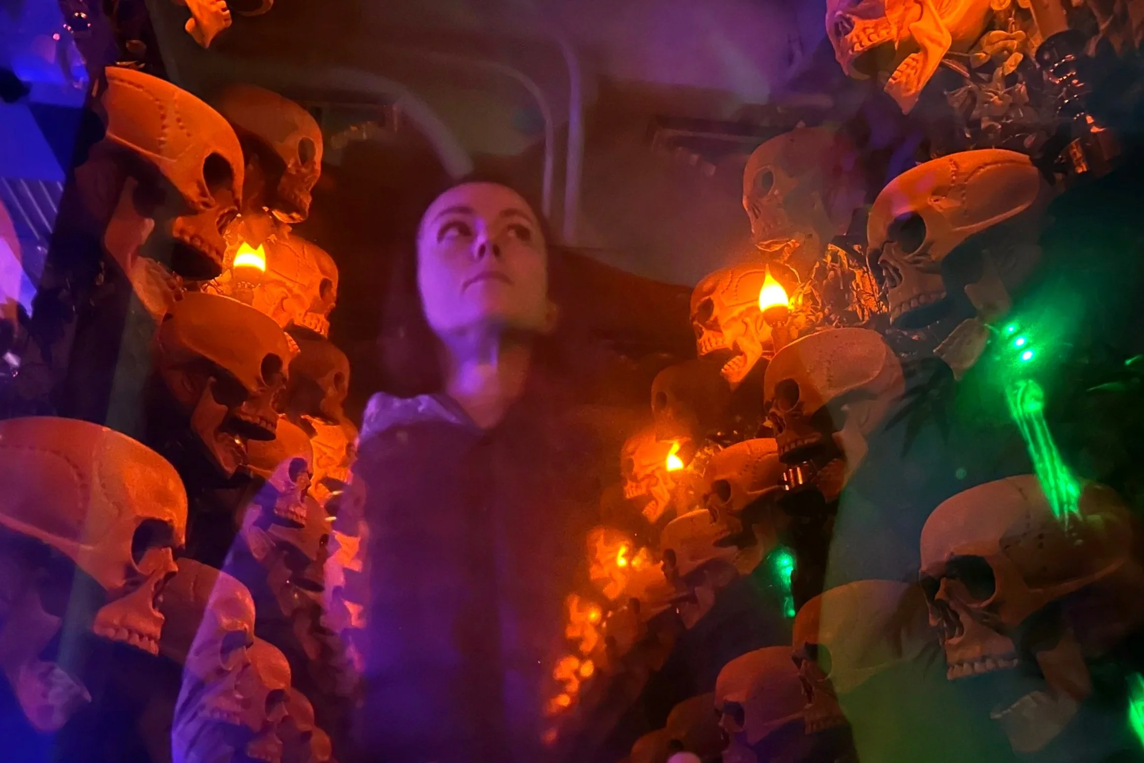 Reflection of woman in hall of skulls