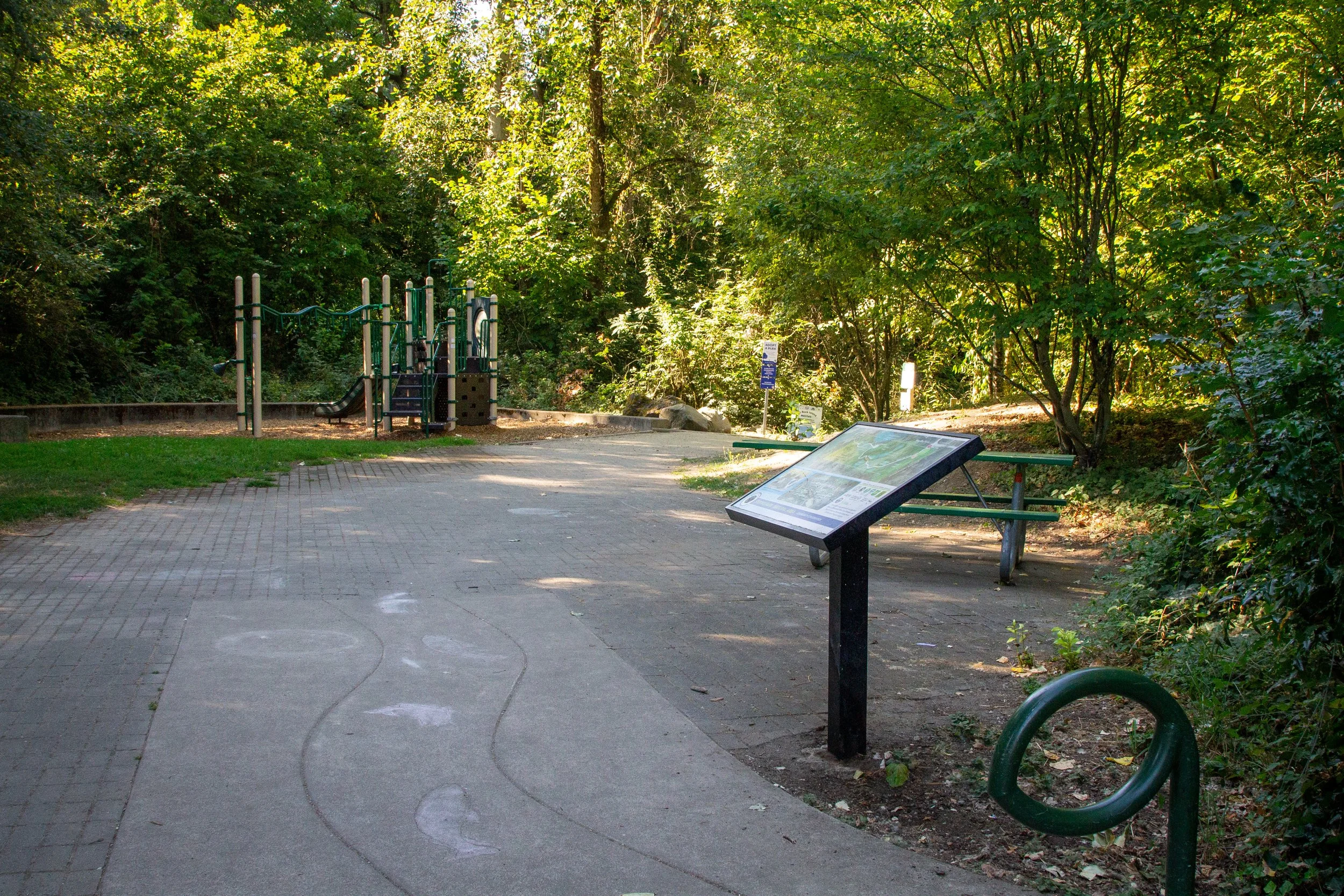 Paved trail and playground in Spring Park Natural Area